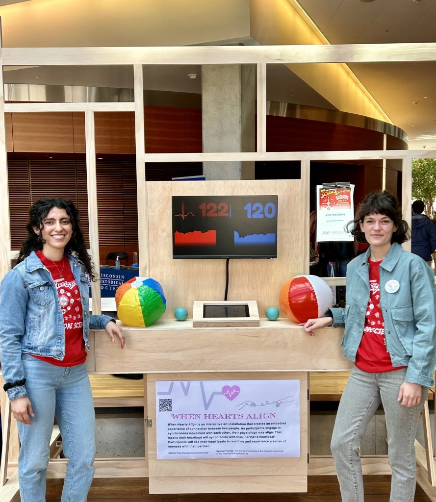 Michelle Marji and Kate Davidson stand with the structure they built to demonstrate when hearts align