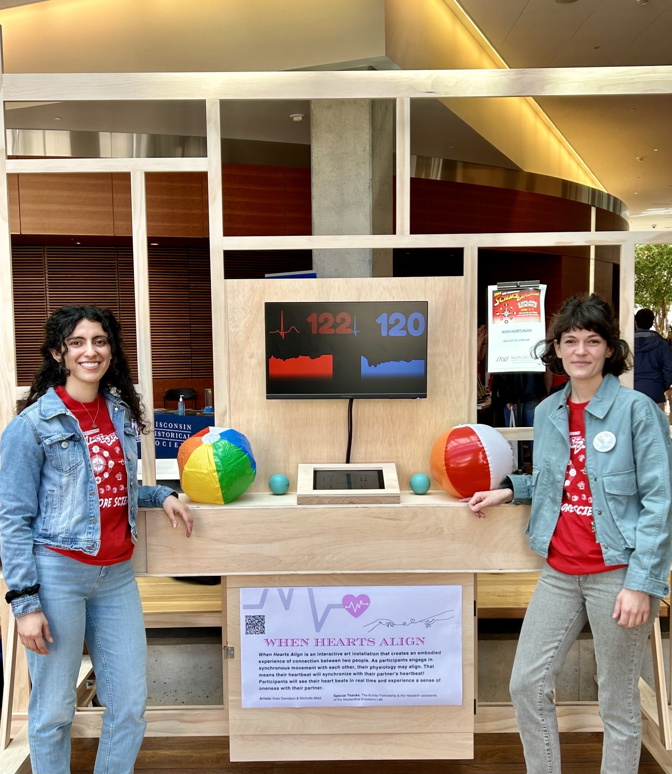Michelle Marji and Kate Davidson stand with the structure they built to demonstrate when hearts align