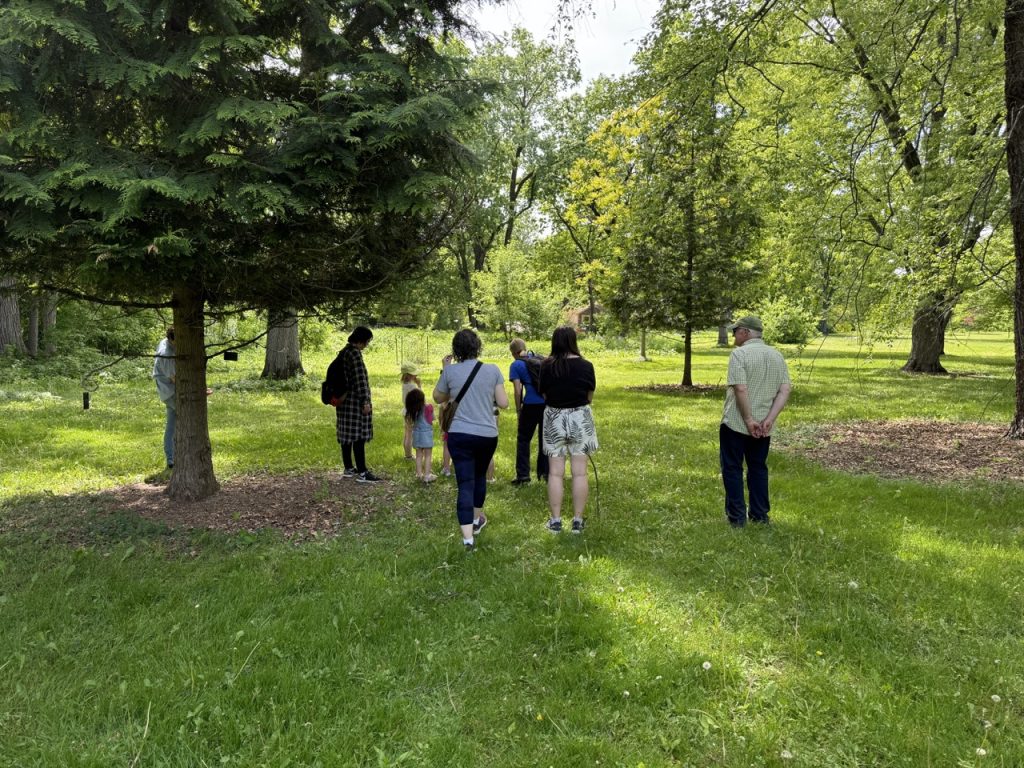 multigenerational people walking in the arboretum