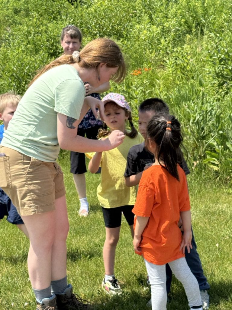 Kohler Fellow showing a group of children an example of nature