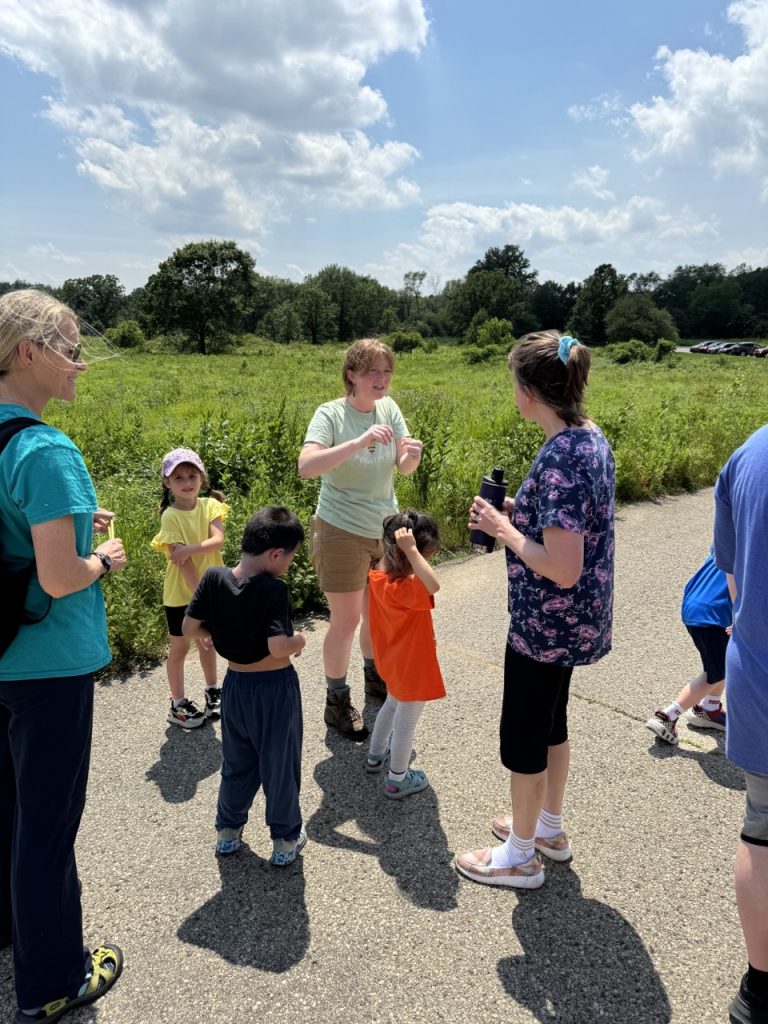 kohler fellow talking to children and older people in the arboretum