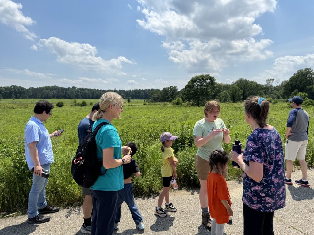 kohler fellow talking to children and older people in the arboretum